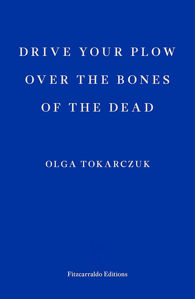 The Fitzcarraldo Editions cover, depicting a plain royal blue with the words 'OLGA TOKARCZUK' and 'DRIVE YOUR PLOW OVER THE BONES OF THE DEAD' in white.